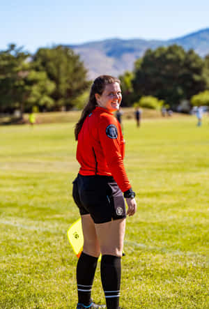 Female Soccer Referee On Field Wallpaper