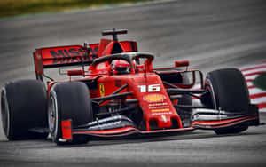 Ferrari F1 Car Driving On A Track Wallpaper