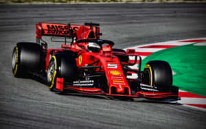 Ferrari F1 Car Driving On A Track Wallpaper