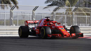 Ferrari F1 Car Driving On A Track Wallpaper