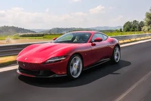 Ferrari Roma Cruising On An Open Road Wallpaper