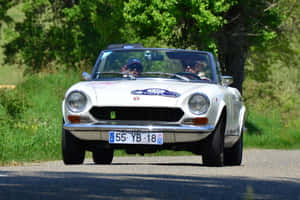 Fiat 124 Spider 2020 - Red Convertible Sports Car Parked In Scenic Landscape Wallpaper