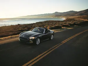Fiat 124 Spider Showcasing Its Elegant Design And Dynamic Stance Wallpaper