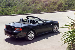 Fiat 124 Spider Tackling The Open Road Wallpaper