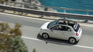 Fiat 500 In Vibrant Cityscape Wallpaper