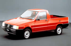 Fiat Fiorino Driving In Urban Landscape Wallpaper