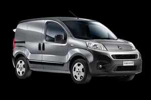 Fiat Fiorino Driving Through A Charming City Street Wallpaper