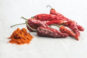 Fiery Red Chili Powder In A Rustic Bowl Wallpaper