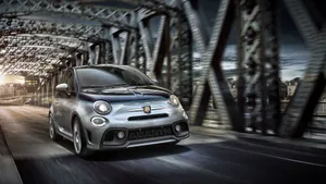 Fiery Red Fiat 500l On A Scenic Road Wallpaper