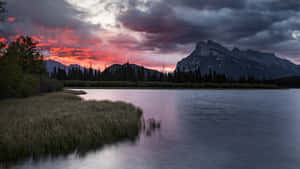 Fiery_ Sunset_ Over_ Mountain_ Lake Wallpaper