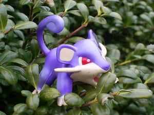 Figurine Of Pokemon Rattata On Green Leaves Wallpaper