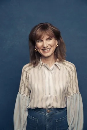 Fiona Bruce Standing Gracefully In A Blue Dress Wallpaper