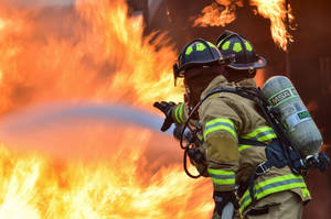 Firefighters In A Scary Operation Wallpaper