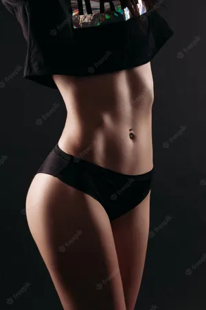 Fit Woman Showcasing Her Perfectly Toned Physique Against A Serene Nature Backdrop Wallpaper