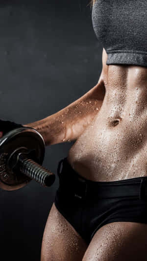 Fitness Focused Female Lifting Weights.jpg Wallpaper