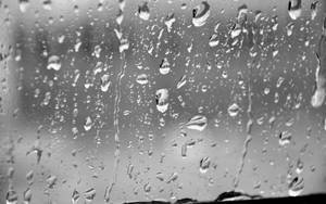 Flowing Raindrops On Glass Surface Greyscale Wallpaper