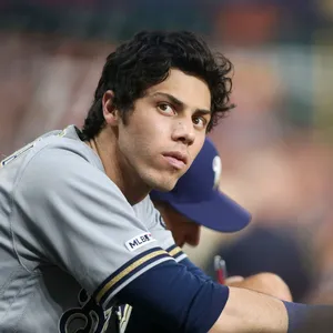 Focused Baseball Player Dugout Moment Wallpaper