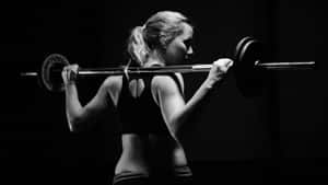 Focused Fitness Enthusiast Barbell Workout.jpg Wallpaper