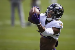 Focused Football Catch Practice Wallpaper