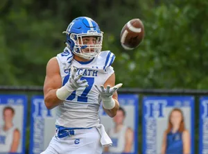 Focused Football Player Catching Ball Wallpaper