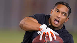 Focused Football Player Catching Ball Wallpaper