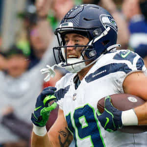 Focused Football Player Catching Ball Wallpaper