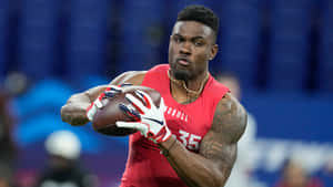 Focused Football Player Catching Ball Wallpaper