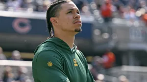 Focused Football Player Christian Watson Wallpaper