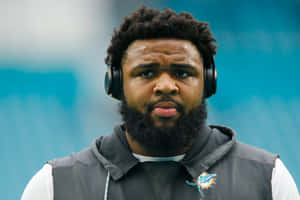 Focused Football Player Christian Wilkins Wallpaper