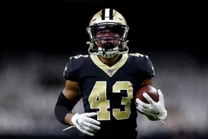 Focused Football Player Holding Ball Wallpaper