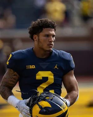 Focused Football Player Holding Helmet Wallpaper