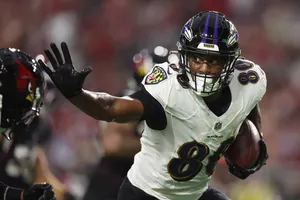 Focused Football Player In Action Wallpaper