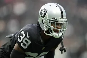 Focused Football Player Nate Hobbs Wallpaper