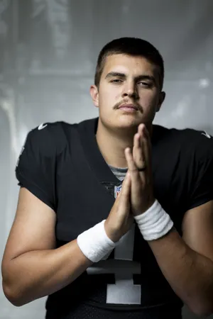 Focused Football Player Portrait Wallpaper