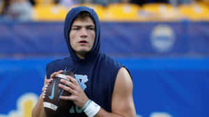 Focused Football Player Preparation Wallpaper