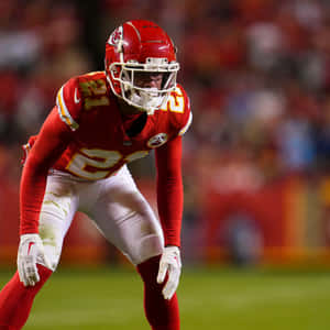 Focused Football Player Readyfor Action Wallpaper