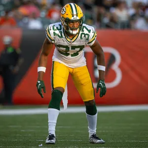 Focused Football Player Readyfor Action Wallpaper