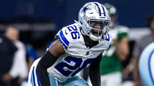 Focused Football Player Readyfor Action Wallpaper