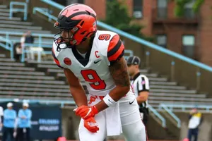 Focused Football Player Readyfor Action Wallpaper