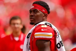 Focused Football Player Red Uniform Wallpaper