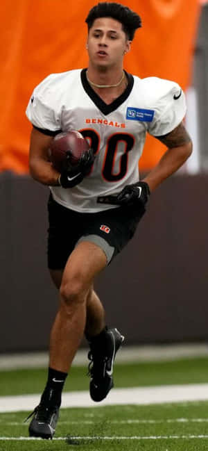 Focused Football Player Running Drill Wallpaper