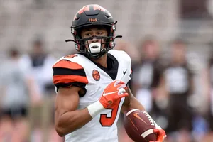 Focused Football Player Running With Ball Wallpaper