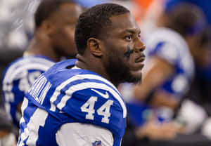 Focused Football Player Sideline Portrait Wallpaper