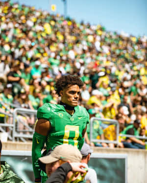 Focused Football Player Stadium Background Wallpaper