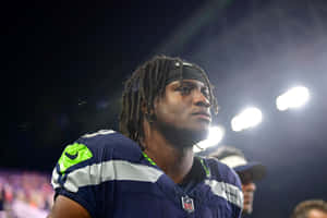 Focused Football Player Stadium Lights Wallpaper