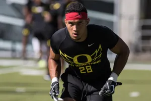 Focused Football Player Training Outdoors Wallpaper