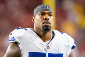 Focused Football Player Tyron Smith Wallpaper