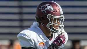 Focused Football Player Wearing Helmet Wallpaper