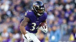 Focused Football Playerin Action Wallpaper