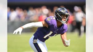 Focused Football Playerin Action Wallpaper